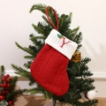 Red knitted Christmas stocking with embroidered letter Y hanging on a festive tree - Letter Y