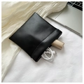 Minimalist black leather mini storage pouch containing a USB cable and lipstick - Large / Black