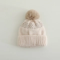 Close-up of cream knit winter hat featuring soft texture and brown faux fur pom-pom - 3-10 Years / Beige