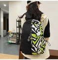 Close-up of trendy nylon backpack with geometric color-block design and astronaut charm - Single Bag / Black Spliced Green