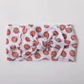 Detailed view of baby headband featuring soft nylon fabric and orange basketball print - White Basketball Pattern