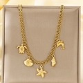 Detail of gold layered necklace with starfish shell sea turtle and dolphin charms - Sea Turtle Shell Dolphin Style (KN293074-SXSJ)