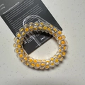 Elastic phone cord hair tie with orange polka dots in a clear spiral design - Polka Dot Orange