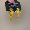 Detailopname van gouden bloemoorbellen met gelaagde bloembladen en een hart van zirkonia - Gouden Bloem Stijl (925 Zilveren Pin)