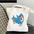 White canvas tote bag featuring a cute corgi dressed in a blue shark onesie print - C9-Shark Corgi