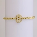 Gold beaded stretch bracelet featuring an 18k gold plated letter B charm with zircon inlay - Letter B