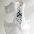 Exaggerated silver and blue multilayered leaf-shaped drop earrings on model - NRXY-1379-1 Silver Blue Glitter