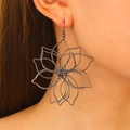 Close-up of artistic black hollow floral earring with intricate metal wire petals on model - Large Hollow Flower Earrings / Gun Black (03 Gun Black N-052)