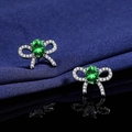 Bow-shaped silver earrings with oval green emerald zircon in professional product photography - Green Diamond Bow Earrings Led-137