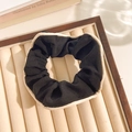 Floral scrunchie in black fabric with beige lace trim and soft pleated texture - Edged Black