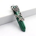 Macro shot of hexagonal malachite pendant with silver floral wire wrapping detail - Malachite