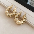 Macro shot of chunky golden bubble hoop earrings featuring a high-polish mirror finish - Gold Bubble Texture (HE29190)