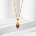 Golden crown necklace featuring a red heart zircon pendant on white steps - Gold Red Zircon Necklace