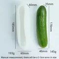 Cucumber shaped white silicone mold for candle making beside a real cucumber - M44 Whole Cucumber