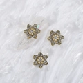 Golden snowflake nail charm with diamonds on shimmering clear false nail - Style A1143-20