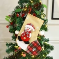 Christmas stocking with snowman and snowflake patterns hanging on a decorated tree - Christmas Snowman Sock
