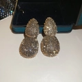 Macro shot of gold double teardrop earrings with luxury vintage pavé texture detail - Antique Gold