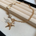 Golden seashell and starfish necklace with freshwater pearl and toggle clasp - Gold Irregular Shell Pearl Starfish Toggle Clasp Necklace