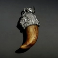 Detailed close-up of a carved stainless steel lion head pendant with resin wolf fang element - Steel Amber Tiger Tooth (No Chain)