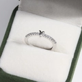 Macro shot of a silver letter Y ring with small crystals in a green velvet box - Platinum Y