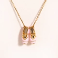 Detail shot of delicate pink enamel ballet slipper pendant on a sleek gold chain - Gold Pink