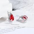 Silver drop earrings featuring vibrant red teardrop crystals on white feather background - A Pair Of Red Diamond Led-125