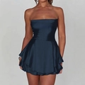 Y2K navy blue satin tube dress with layered ruffle hem shown on a model against grey wall - S / Navy Blue