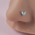 Silver nose stud with blue marquise gemstones in leaf shape on model's nose - Blue Double Marquise