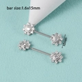 Macro detail of silver flower nipple rings with 1.6x15mm bar and 10mm zircon floral heads - Sunflower