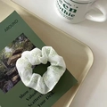 Elegant white organza scrunchie with green floral pattern displayed on a tray - Green Hollow Flower