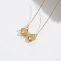 Elegant gold bow pendant necklace with sparkling cubic zirconia on a white background - Large Polished Zirconia Bowknot
