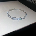 Detailopname van glinsterende zilveren armband met zirkonia pavé en ronde hoofdstenen - Hart Open Stijl / Zilver - Hart