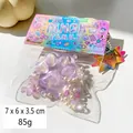 Glittery purple cat paw squishy toy with beads and pearls in Pinch Family packaging - Crystal Polarized Purple Cat Claw