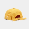 Detail of yellow canvas docker hat featuring white airplane embroidery and bronze buckle - Adjustable / Yellow