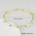 Detail showing the 5.84cm diameter and 7g weight of the gold evil eye bangle - Navy Blue White Evil Eye