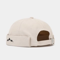 Detail of mountain embroidery and adjustable silver buckle on beige cotton docker cap - Beige