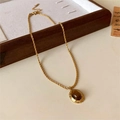 Golden twist rope necklace featuring a vintage oval amber stone pendant on a beige liner - 31# Necklace-Gold