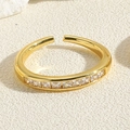 Detailed close-up of a gold-plated adjustable ring with square-cut clear zircon stones - Square White Zirconia
