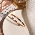 Polished rose gold stainless steel bangle featuring a faceted geometric diamond cut design - 4mm Width / Rose Gold