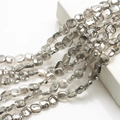 Macro shot of 12mm grey faceted glass beads with brilliant clarity for DIY jewelry making - Smoke Gray