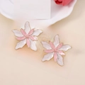 Detail view of pink and white enamel double layer flower stud earrings on display card - Pink