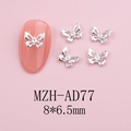 Close-up of silver hollow butterfly nail charm with rhinestones on pink mannequin nail - Silver Hollow Wing Butterfly (AD77)