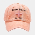 Macro shot of distressed peach cotton baseball cap with Give Blood embroidery - Pink
