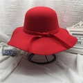 Red wool felt cloche hat with a decorative bow on a stylish vintage metal display stand - Bright Red (10cm Brim)