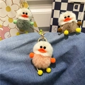 Portachiavi a forma di anatra in peluche arancione, verde e marrone su sfondo denim - Rosa