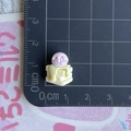 Mini pink resin ice cream accessory with colorful sprinkles on a scale measurement mat - Yellow Cheese Purple Ice Cream