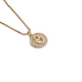 Minimalist gold heart zircon necklace featuring a crystal-encrusted round pendant on a thin chain - Round Hollow Heart With Zirconia