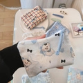 Close-up of blue cotton mini pouch with bear pattern and a simple wish brand tag - Dog