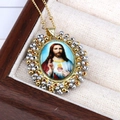 Close-up of Sacred Heart of Jesus religious pendant with colorful beads and gold chain - Sacred Heart of Jesus / Gray