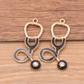 Black enamel stethoscope charm with clear crystal accent on wood background - Large Stethoscope - Rhinestone / Gold/Black